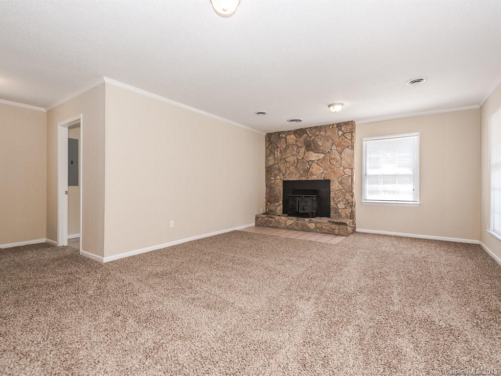 2314 Goldmine Road Monroe, NC 28110 - Photo 9 of 24 an empty room with windows and fireplace