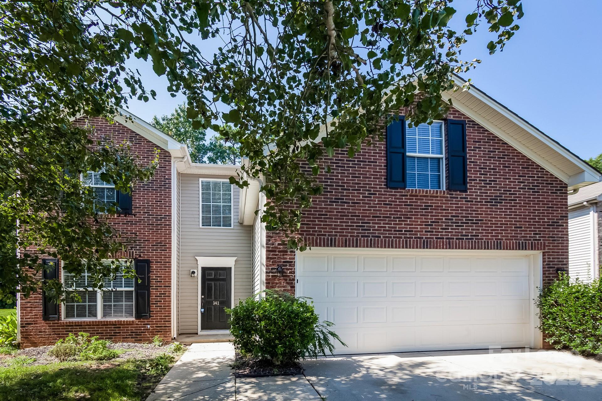 a house that has a tree in front of the house