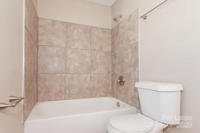 a white bath tub sitting next to a white toilet and sink