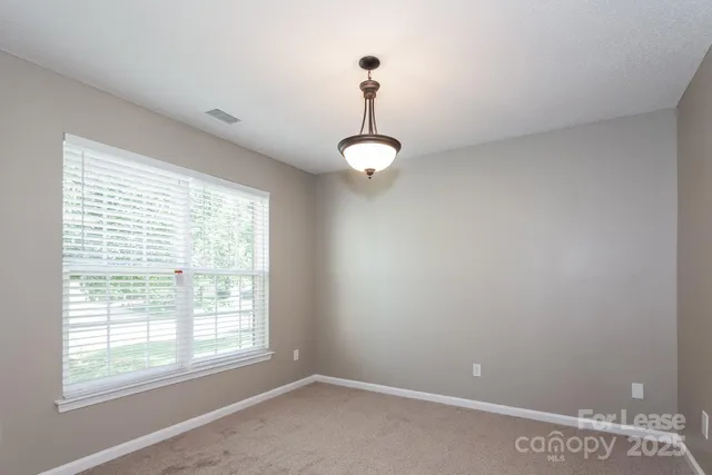 a view of a room with a window and ceiling fan