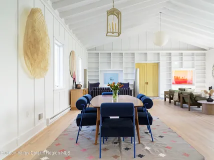 a dining room with furniture and wooden floor