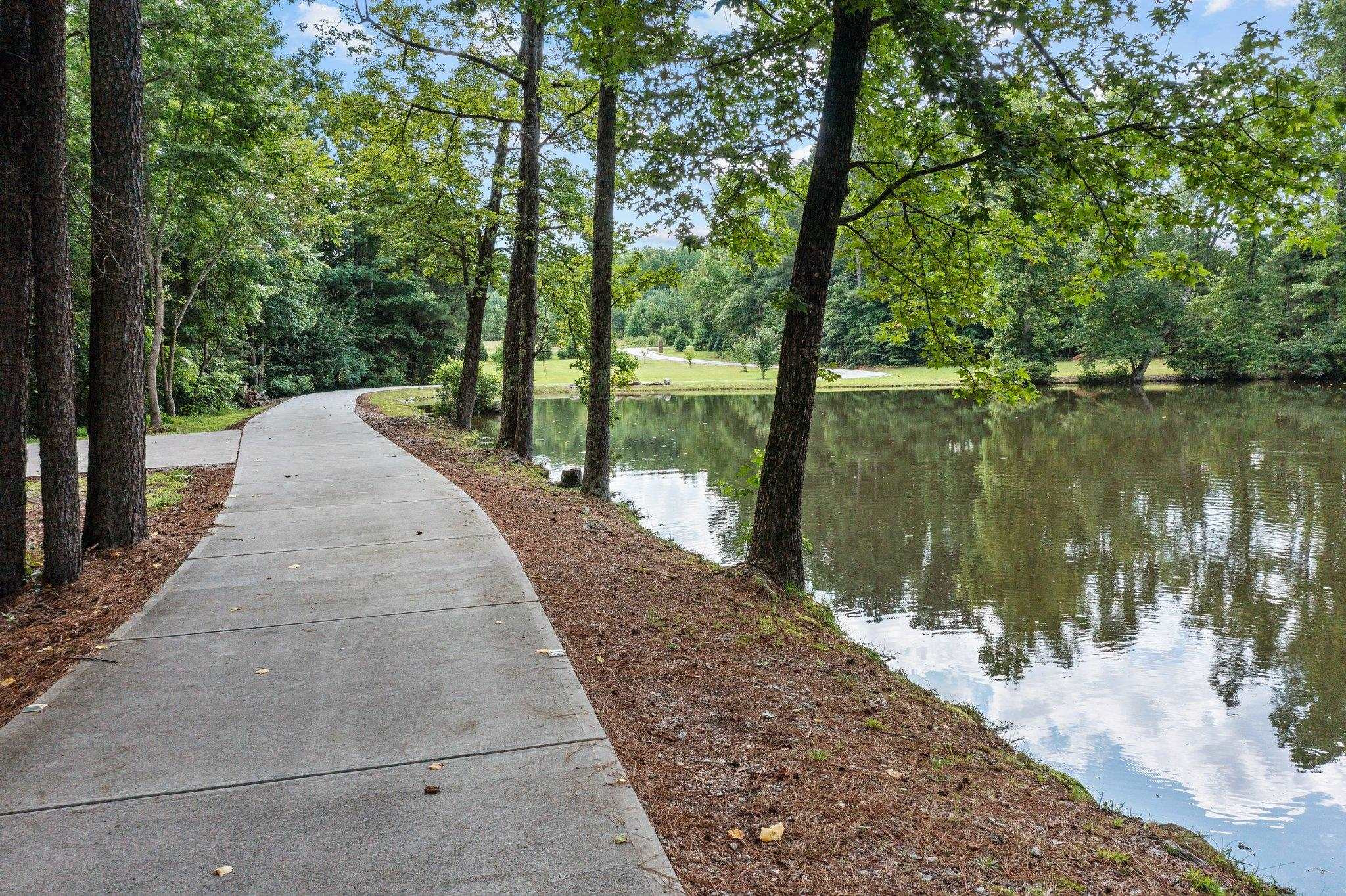 312 P G Pearce Road Zebulon, NC 27597 - Photo 2 of 57 Enjoy a lazy afternoon fishing in your pond. Concrete Driveway all the way to the home.