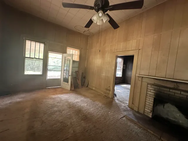 a large dining hall with stainless steel appliances granite countertop a rug stove top oven and cabinets