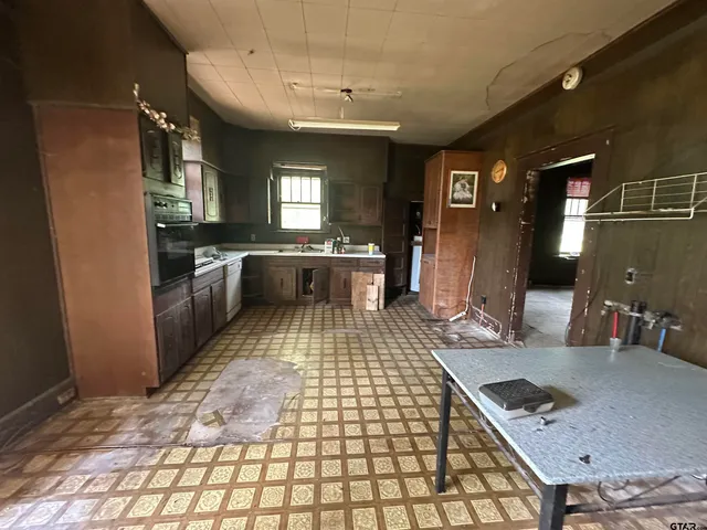 a bathroom with sink a mirror and shower
