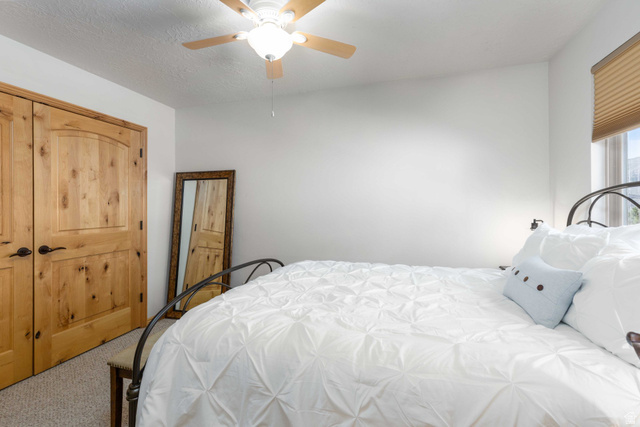5168 Fairview Loop, Unit C604 Eden, UT 84310 - Photo 19 of 53 Bedroom with carpet, ceiling fan, and a textured ceiling