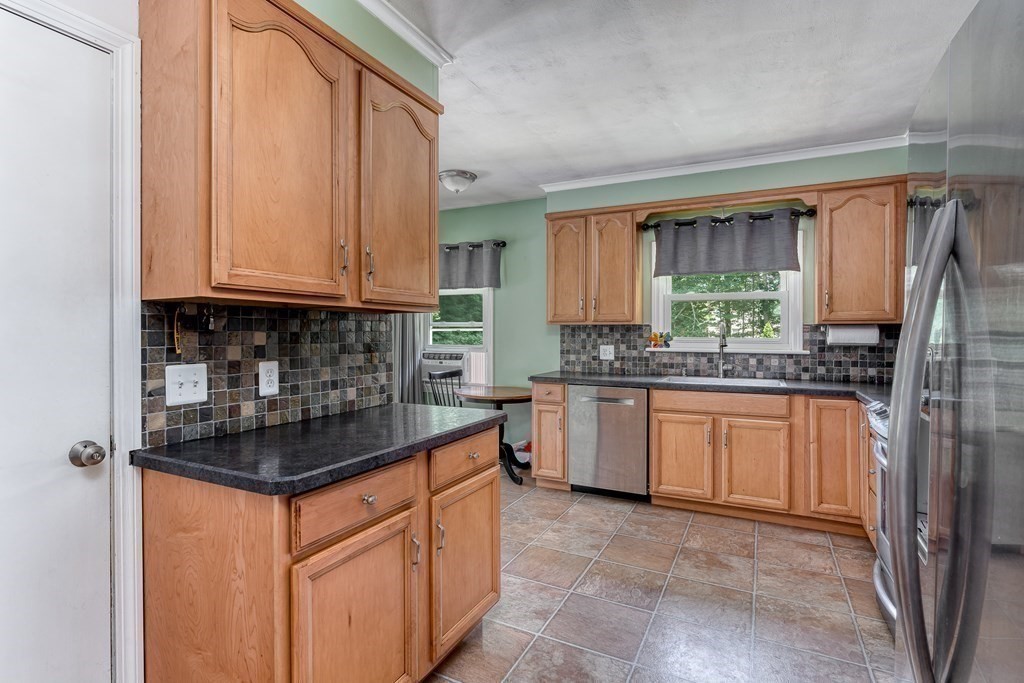 1929 Allen Street Springfield, MA 01118 - Photo 12 of 38 a kitchen with stainless steel appliances granite countertop a stove a sink and a refrigerator