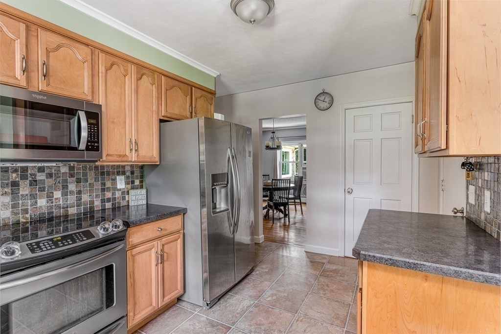1929 Allen Street Springfield, MA 01118 - Photo 13 of 38 a kitchen with stainless steel appliances granite countertop a stove a sink and a microwave