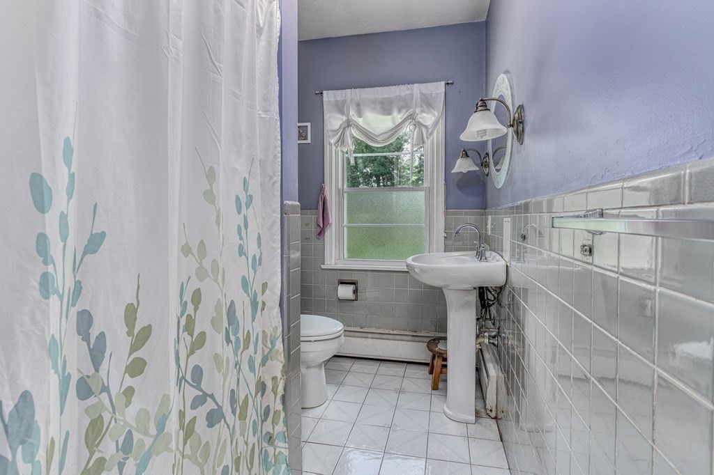 1929 Allen Street Springfield, MA 01118 - Photo 16 of 38 a bathroom with a sink toilet and a mirror