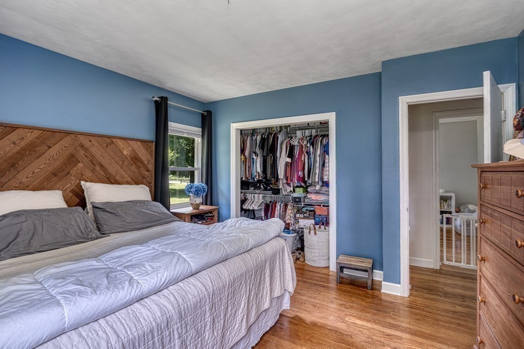1929 Allen Street Springfield, MA 01118 - Photo 21 of 38 a bedroom with a bed and wooden floor