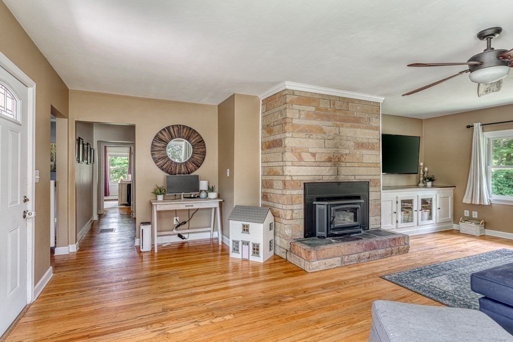 1929 Allen Street Springfield, MA 01118 - Photo 7 of 38 a living room with furniture a fireplace and wooden floor