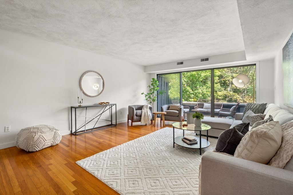 120 Beaconsfield Road, Unit 12 Brookline, MA 02445 - Photo 8 of 32 a living room with furniture and a large window