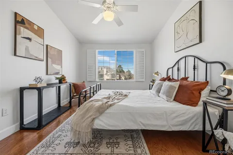 a bedroom with bed and wooden floor