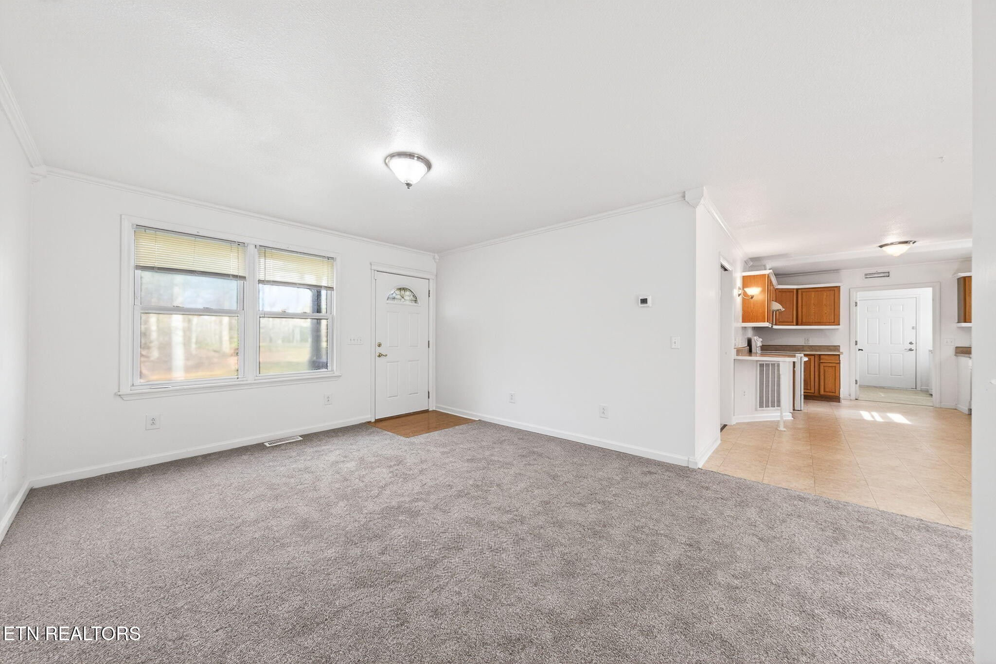4067 Blaylock Road Crossville, TN 38572 - Photo 5 of 17 an empty room with a kitchen and a window