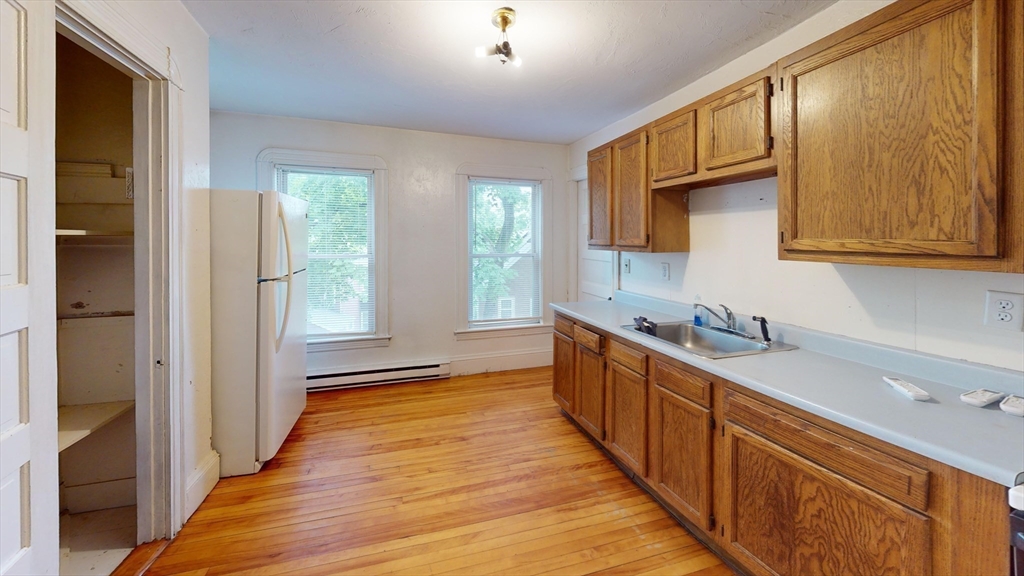51 Uxbridge Street Worcester, MA 01605 - Photo 27 of 33 a kitchen with stainless steel appliances granite countertop a sink and wooden cabinets