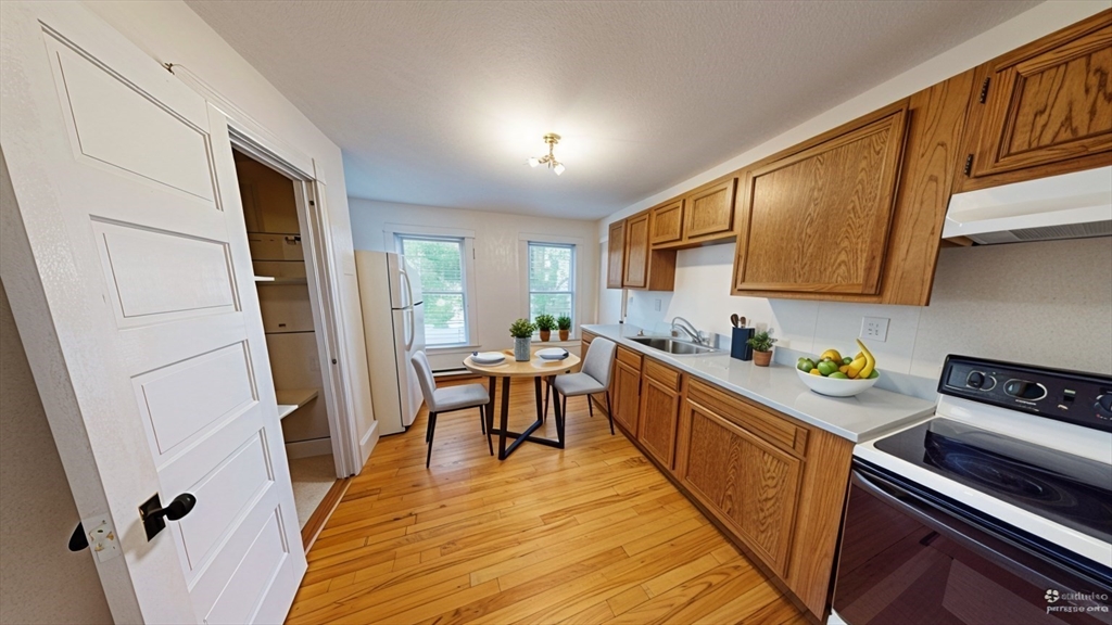 51 Uxbridge Street Worcester, MA 01605 - Photo 28 of 33 a kitchen with a refrigerator a stove top oven a sink and dishwasher