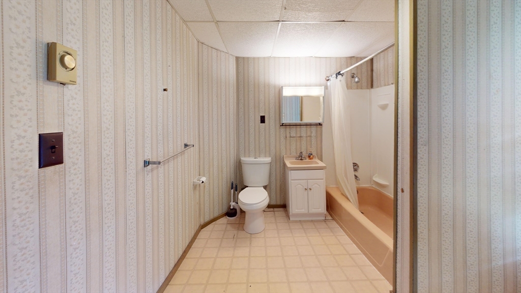51 Uxbridge Street Worcester, MA 01605 - Photo 29 of 33 a bathroom with a granite countertop shower and a toilet