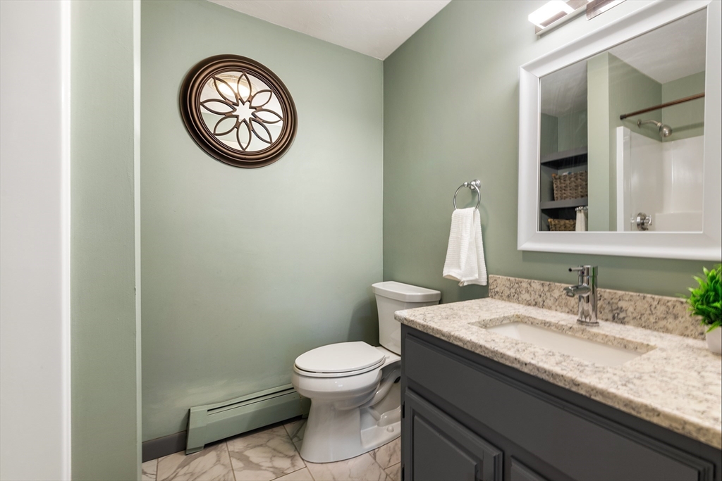 6 Crestlan Drive Worcester, MA 01604 - Photo 16 of 33 a bathroom with a granite countertop toilet a sink and mirror