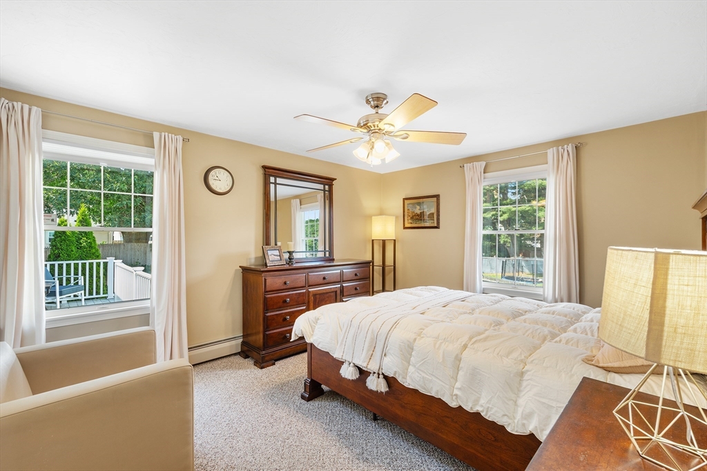6 Crestlan Drive Worcester, MA 01604 - Photo 19 of 33 a bedroom with a bed and a chandelier