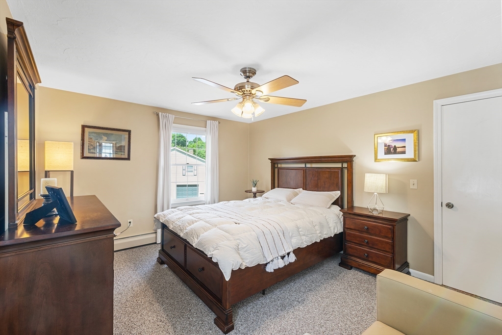 6 Crestlan Drive Worcester, MA 01604 - Photo 20 of 33 a bedroom with a bed and a chandelier
