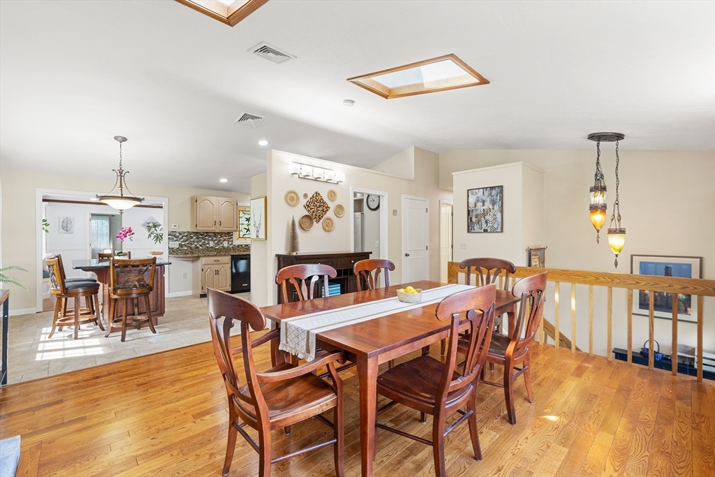 6 Crestlan Drive Worcester, MA 01604 - Photo 6 of 33 a view of a dining room and livingroom with furniture wooden floor a rug a painting and a chandelier