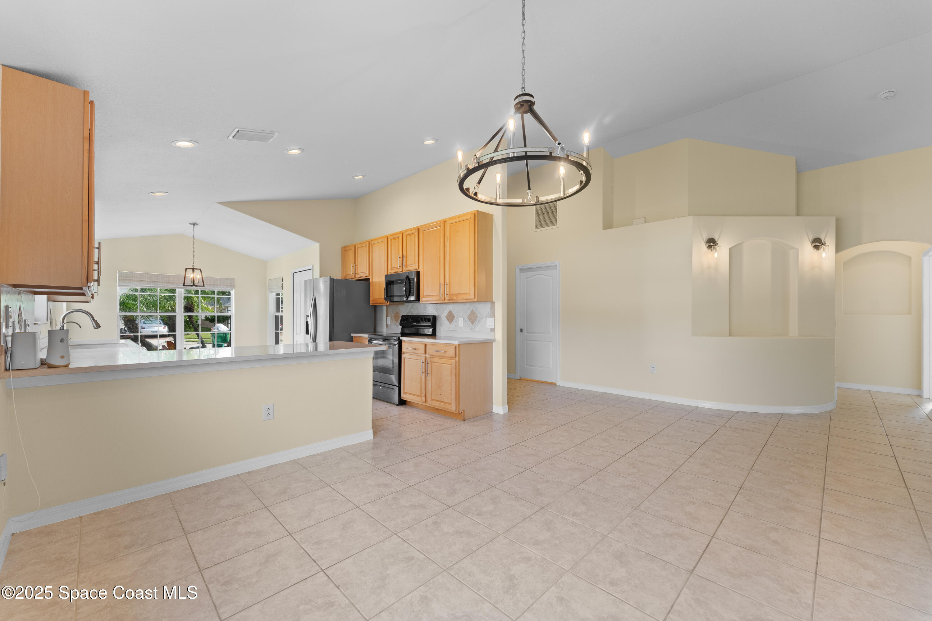 3112 Siderwheel Drive Rockledge, FL 32955 - Photo 15 of 60 a view of a kitchen with furniture and chandelier