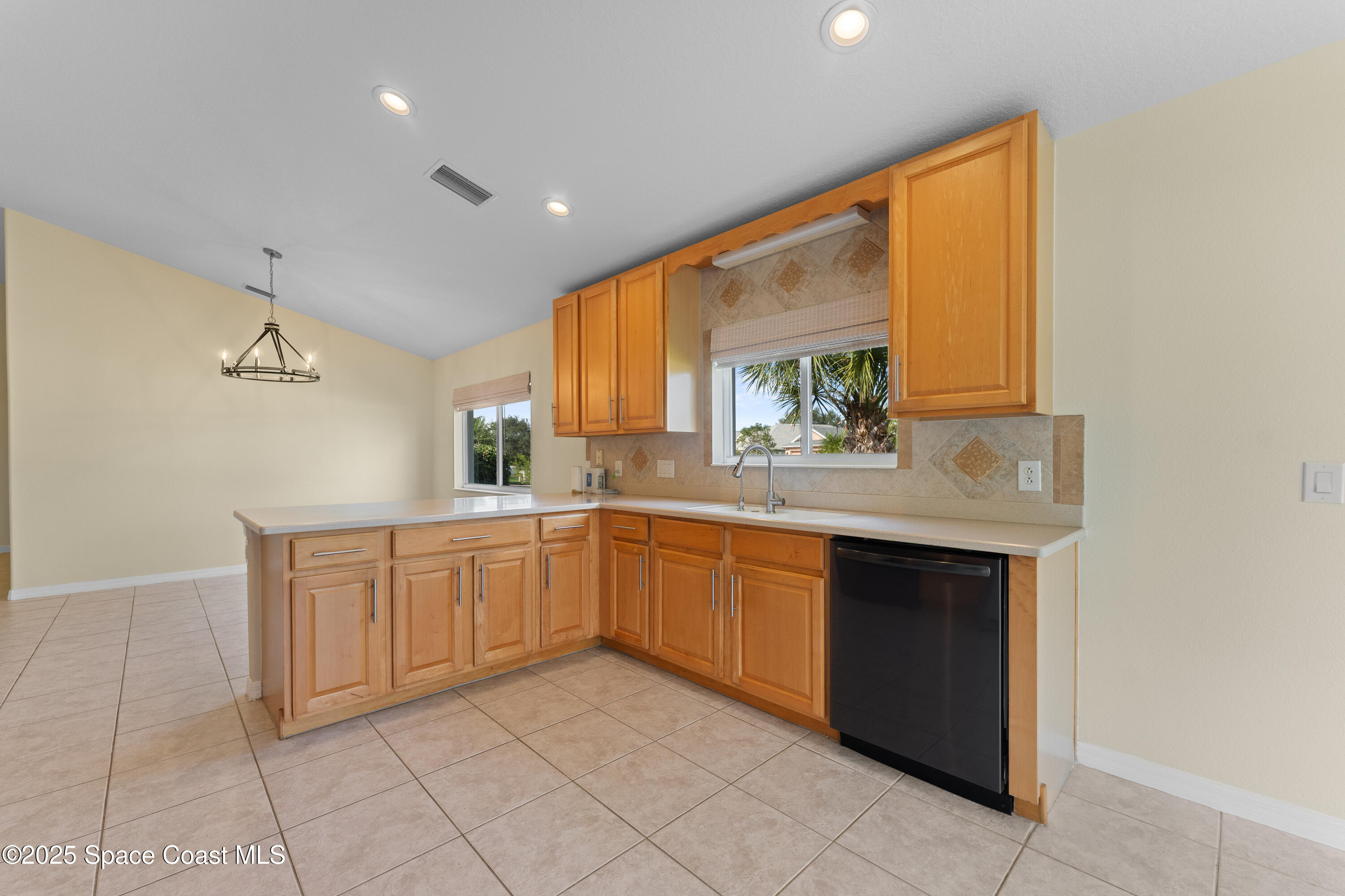 3112 Siderwheel Drive Rockledge, FL 32955 - Photo 18 of 60 a large kitchen with a sink and cabinets
