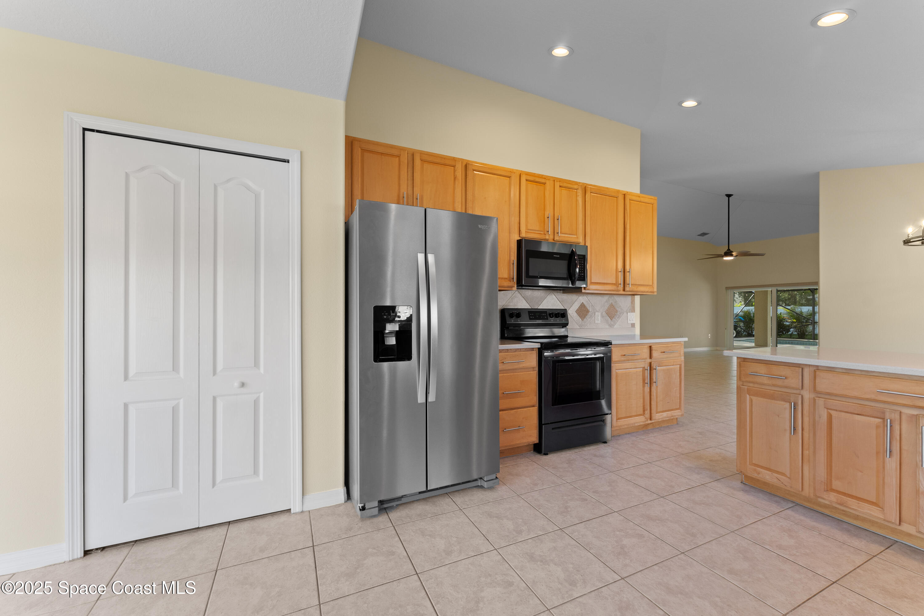3112 Siderwheel Drive Rockledge, FL 32955 - Photo 19 of 60 a kitchen with stainless steel appliances a refrigerator and a stove top oven