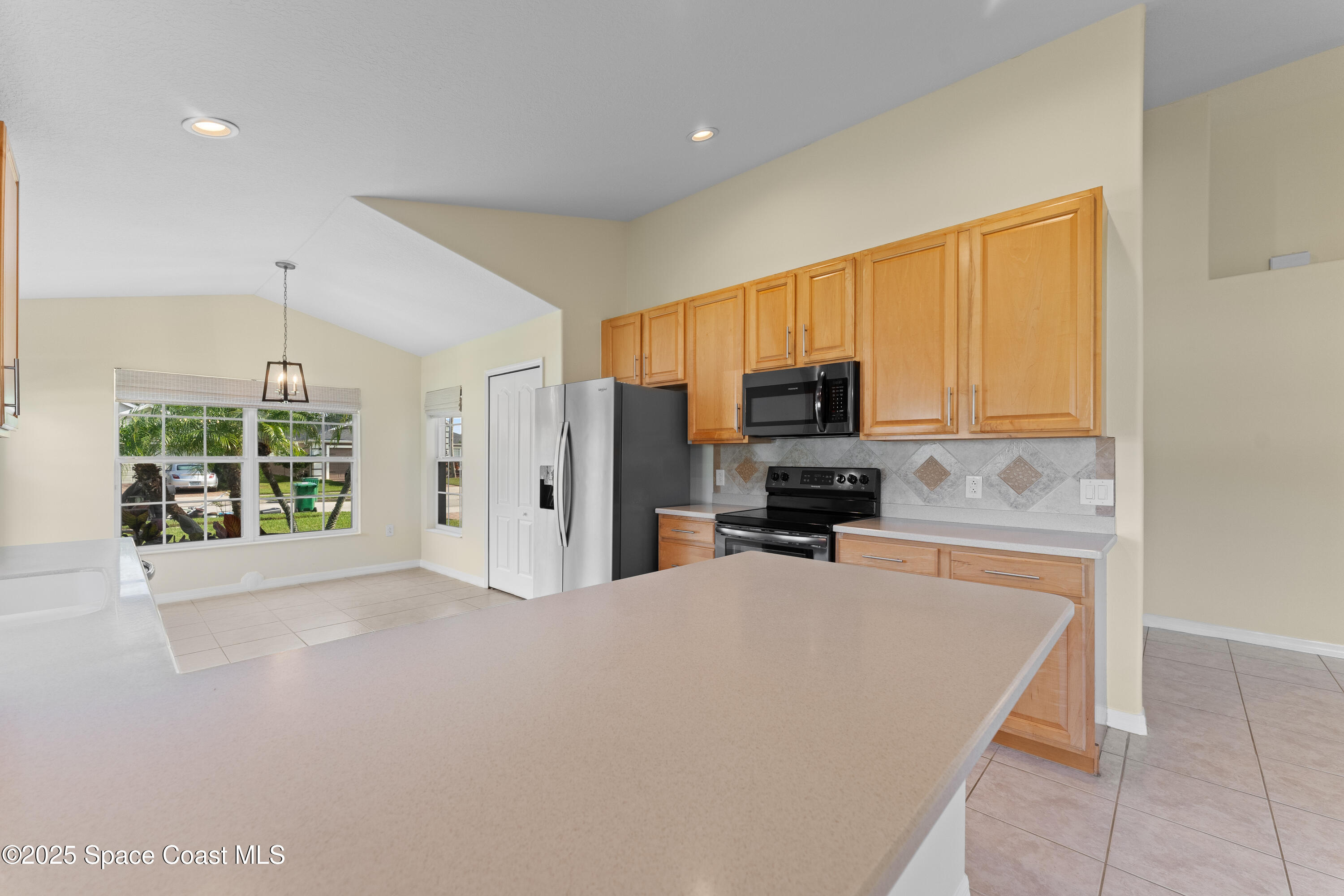 3112 Siderwheel Drive Rockledge, FL 32955 - Photo 20 of 60 a large kitchen with a large window and a refrigerator
