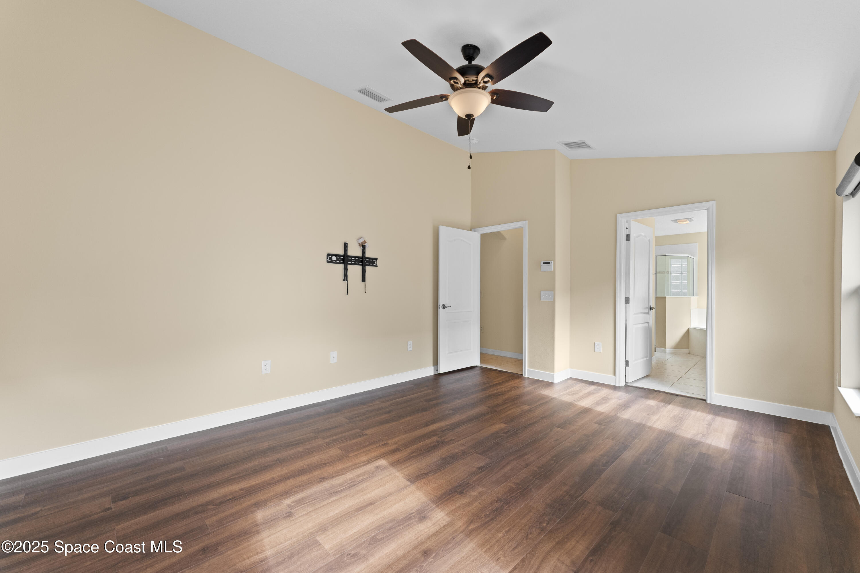 3112 Siderwheel Drive Rockledge, FL 32955 - Photo 22 of 60 an empty room with wooden floor and a ceiling fan