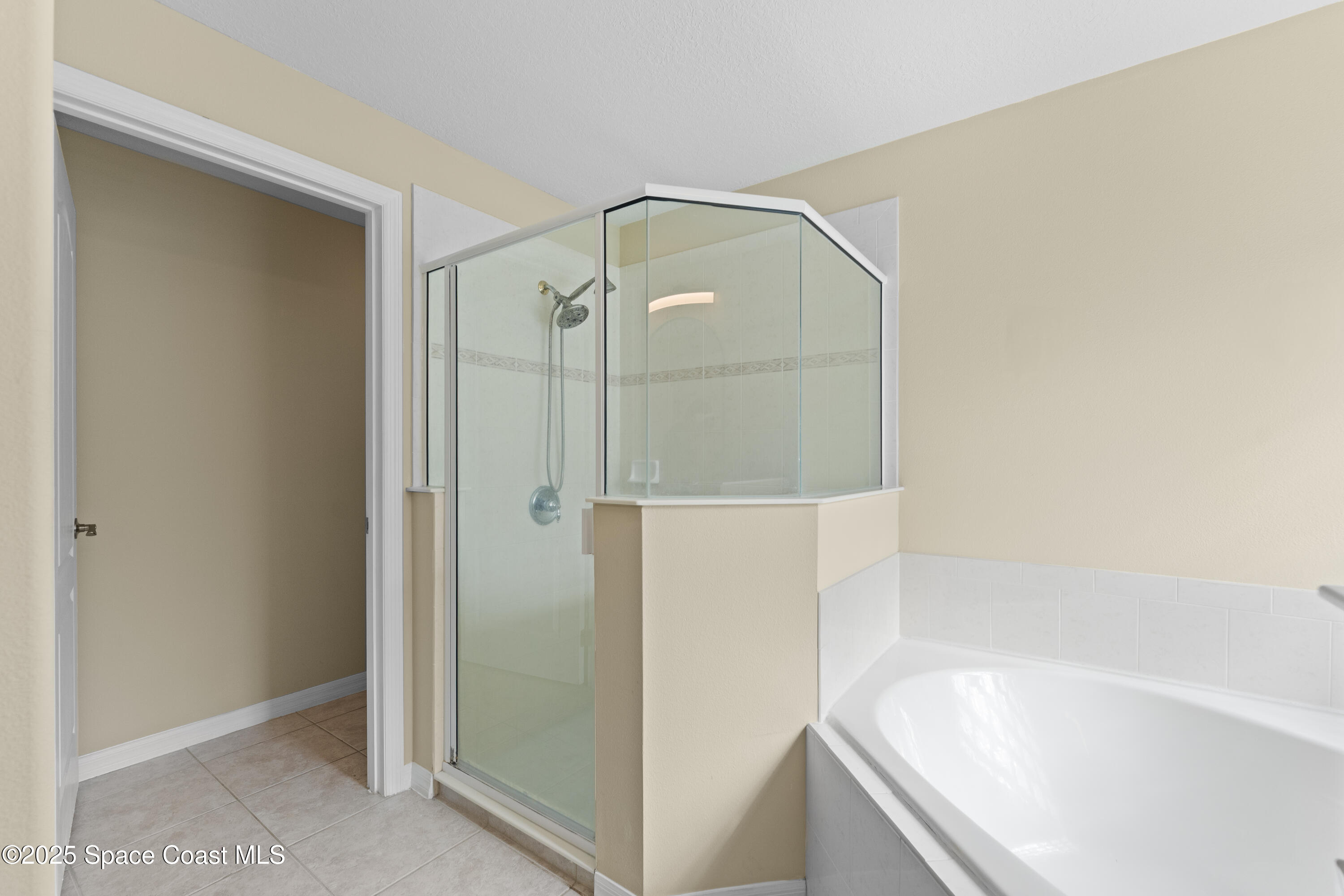 3112 Siderwheel Drive Rockledge, FL 32955 - Photo 24 of 60 a bathroom with a bathtub and a shower