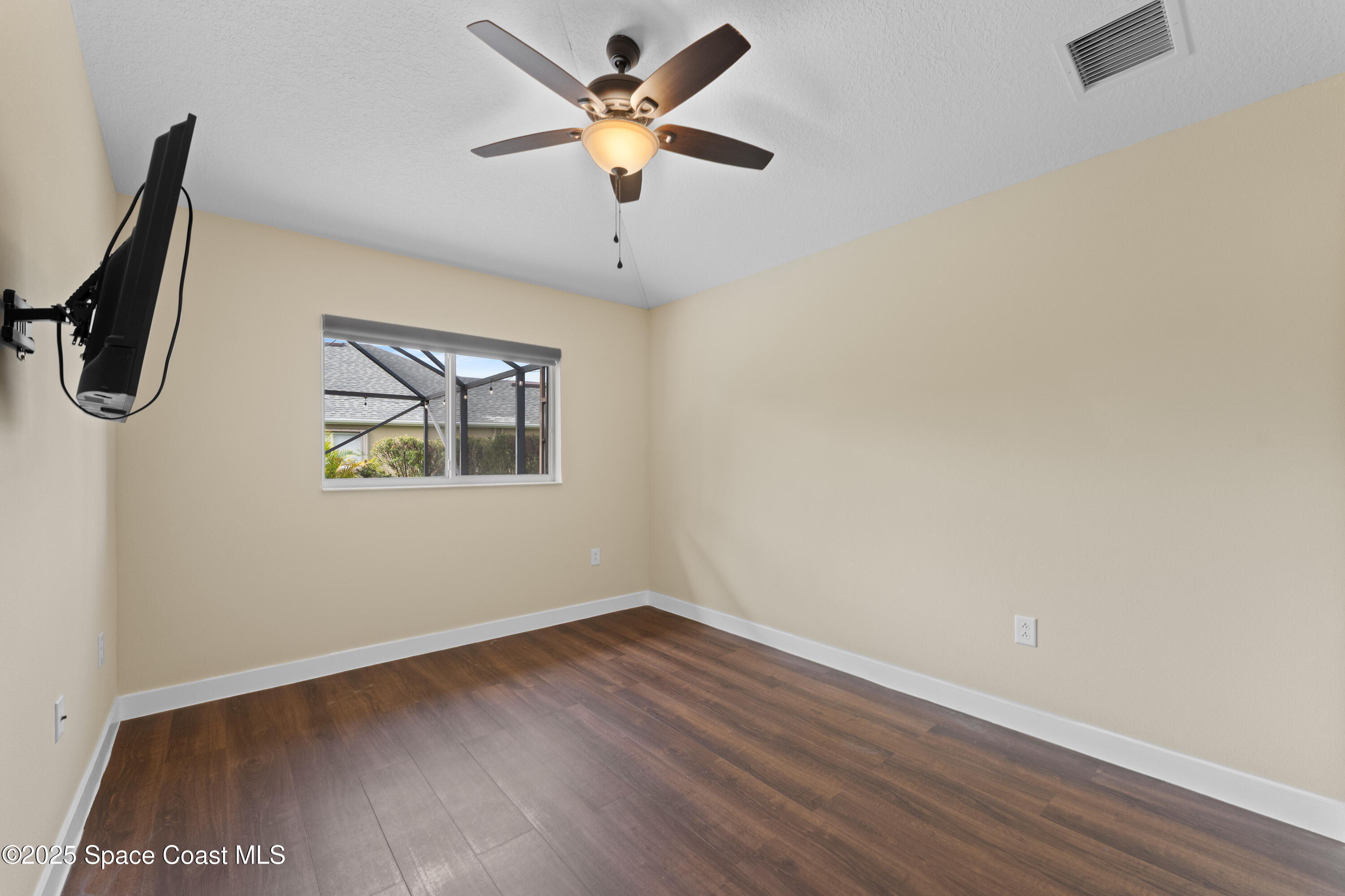 3112 Siderwheel Drive Rockledge, FL 32955 - Photo 31 of 60 an empty room with wooden floor and ceiling fan