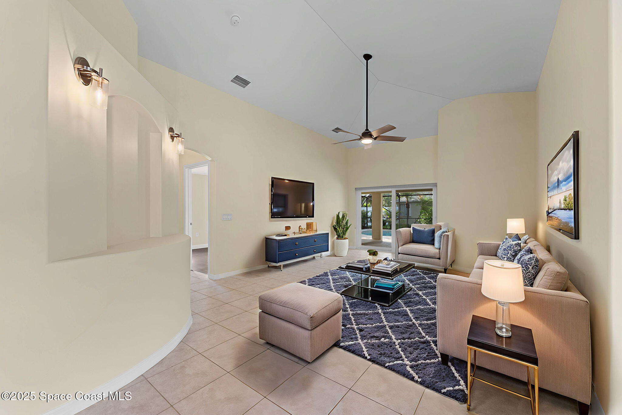 3112 Siderwheel Drive Rockledge, FL 32955 - Photo 4 of 60 a living room with furniture a flat screen tv and a window