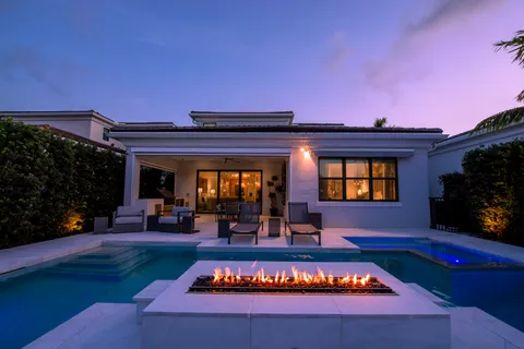 a living room with furniture a chandelier and a flat screen tv