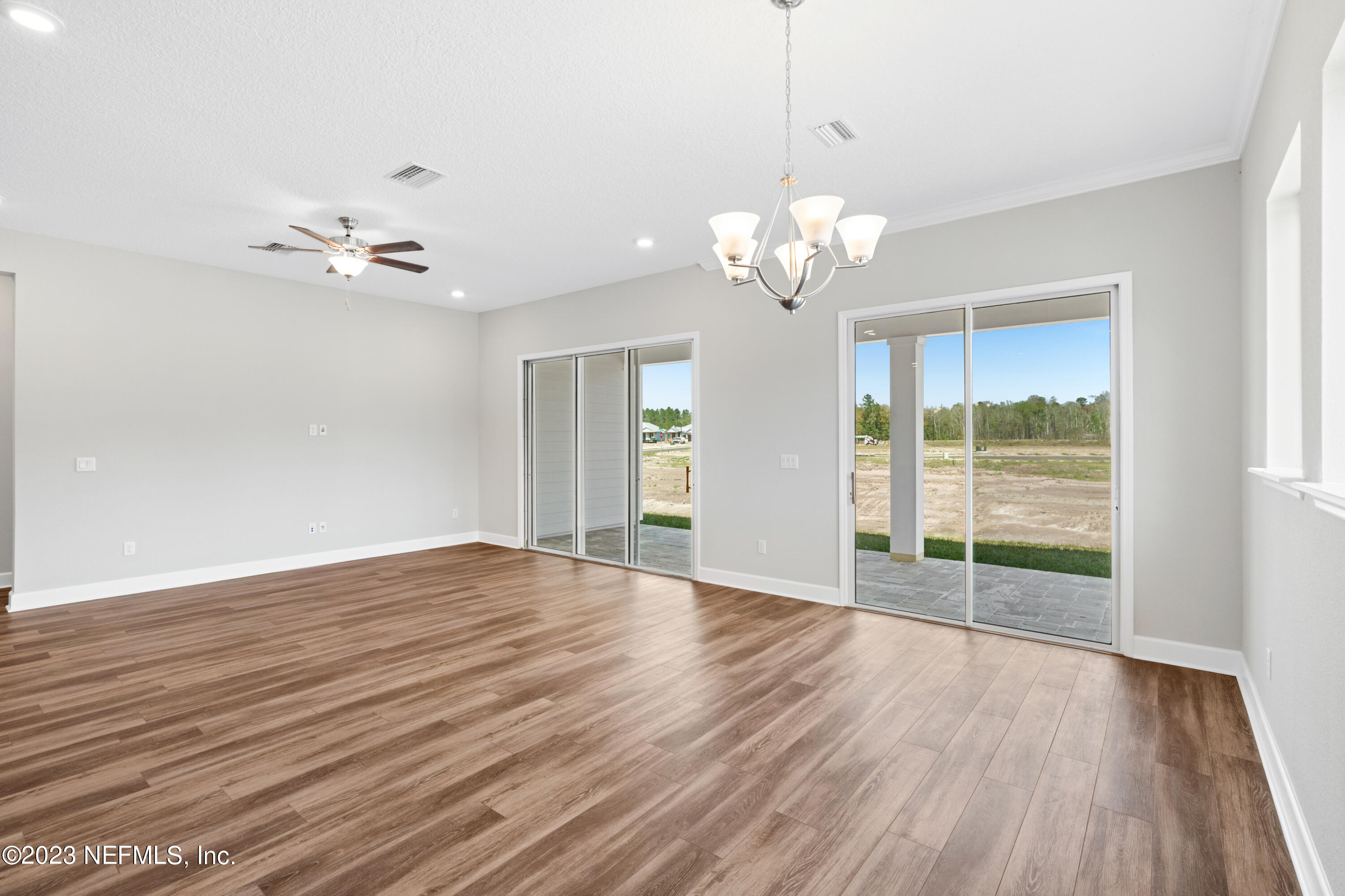 21 Willow Island Point St. Augustine, FL 32092 - Photo 6 of 14 a view of an empty room with a window and wooden floor