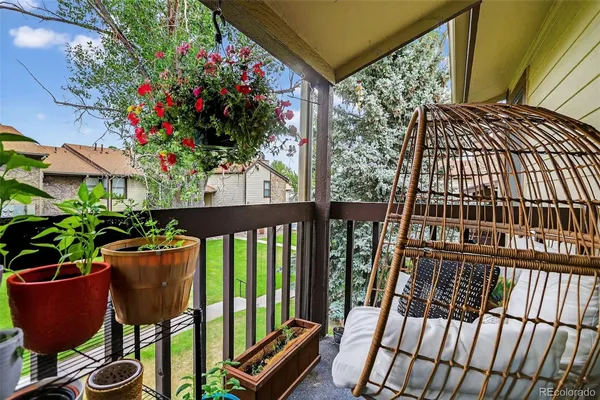 a view of a chairs and table in the balcony