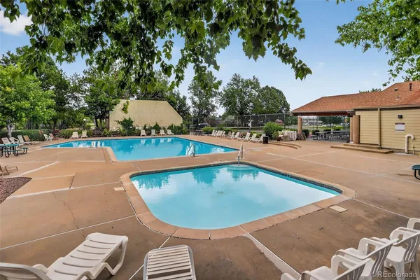 an outdoor space with pool and furniture