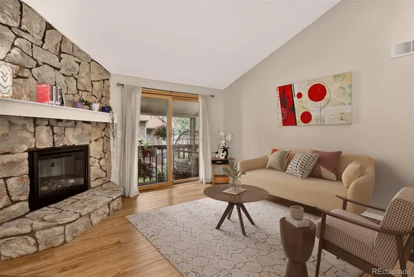 a living room with furniture and a fireplace