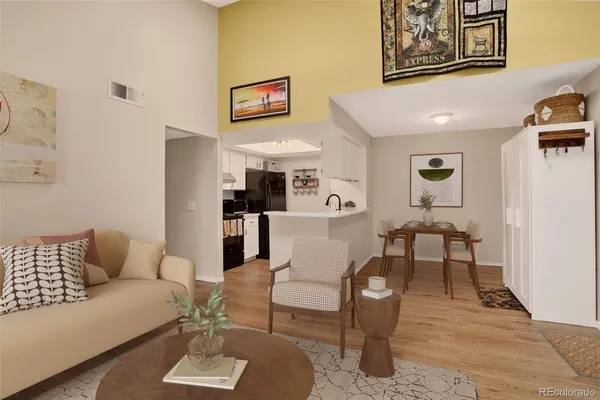 a living room with furniture and kitchen view
