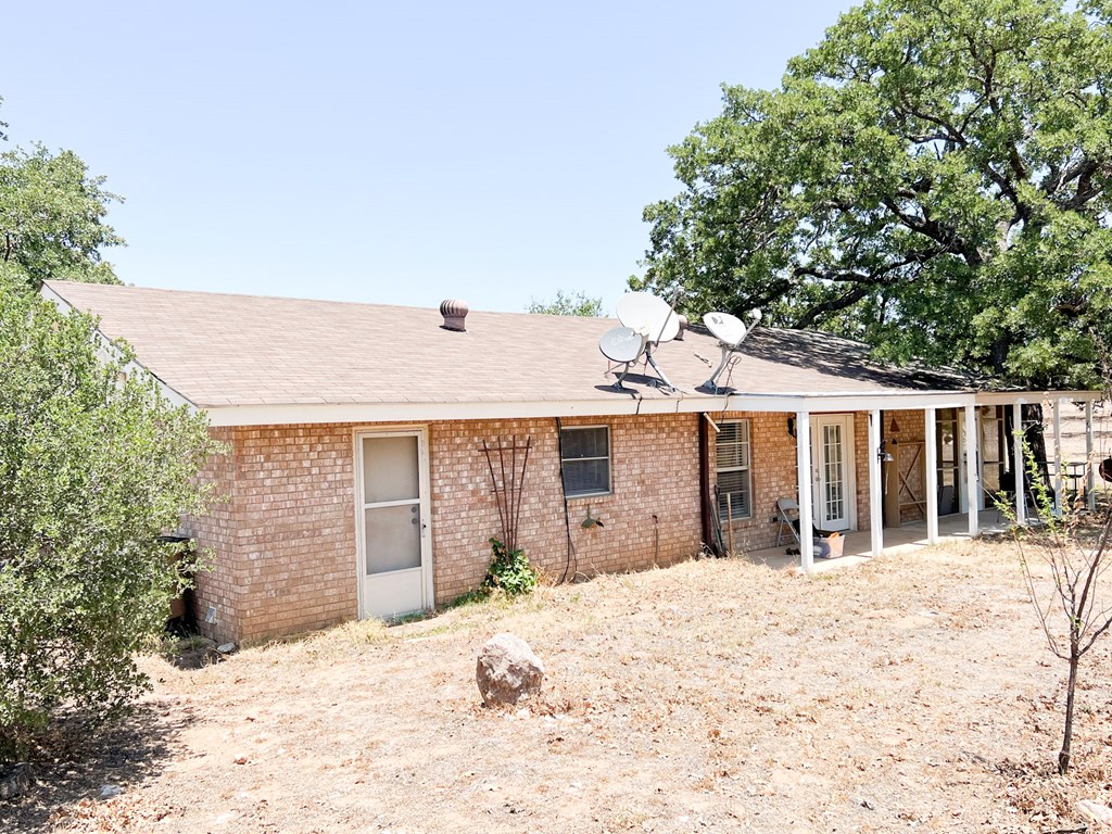 110 Cortez Buchanan Dam, TX 78609 - Photo 2 of 17 a view of a house with a yard and covered with trees