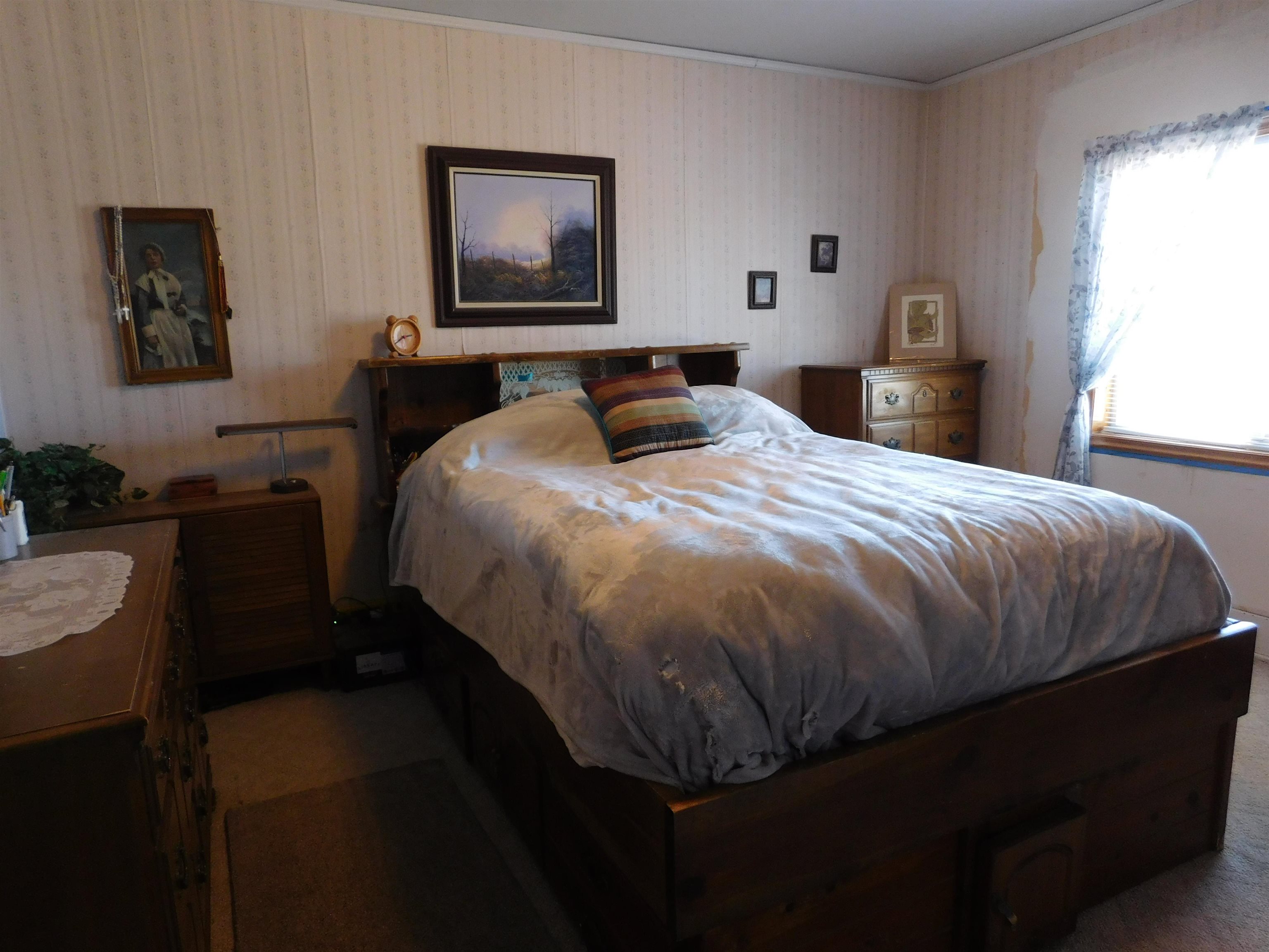 923 18 Road Fruita, CO 81521 - Photo 7 of 33 a bedroom with a bed and dresser