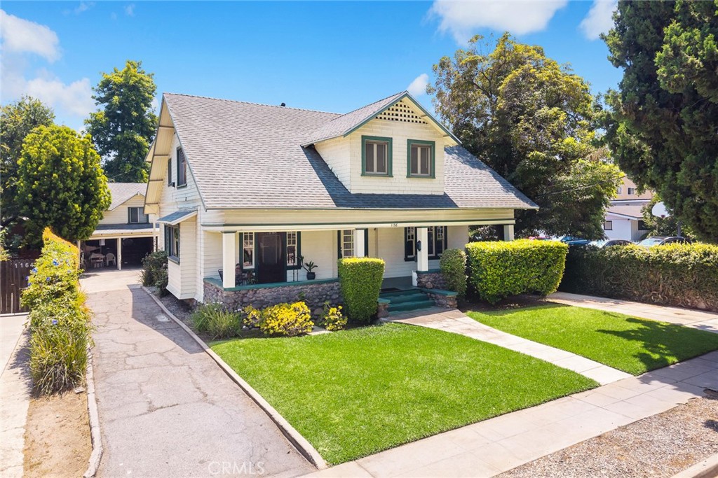 a front view of a house with garden and porch