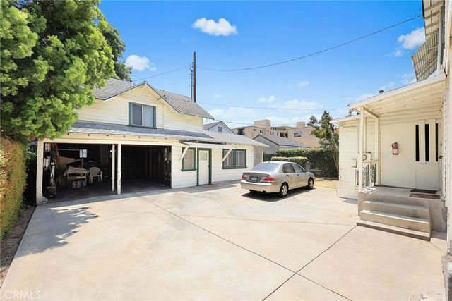 a view of a car parked in front of house