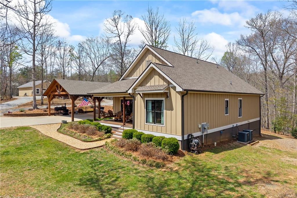 5240 Highway 17 Clarkesville, GA 30523 - Photo 2 of 82 a front view of house with yard and trees in the background