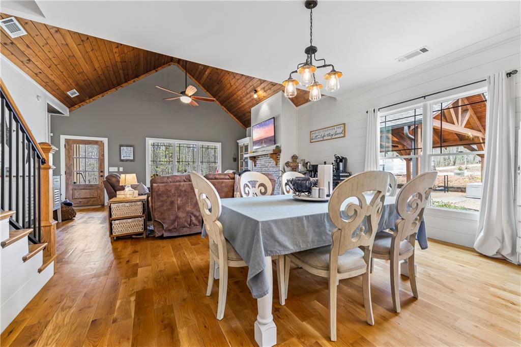 5240 Highway 17 Clarkesville, GA 30523 - Photo 33 of 82 a view of a dining room with furniture a chandelier and wooden floor