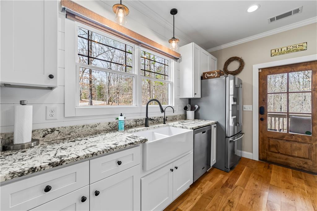5240 Highway 17 Clarkesville, GA 30523 - Photo 36 of 82 a kitchen with granite countertop a sink stainless steel appliances and cabinets