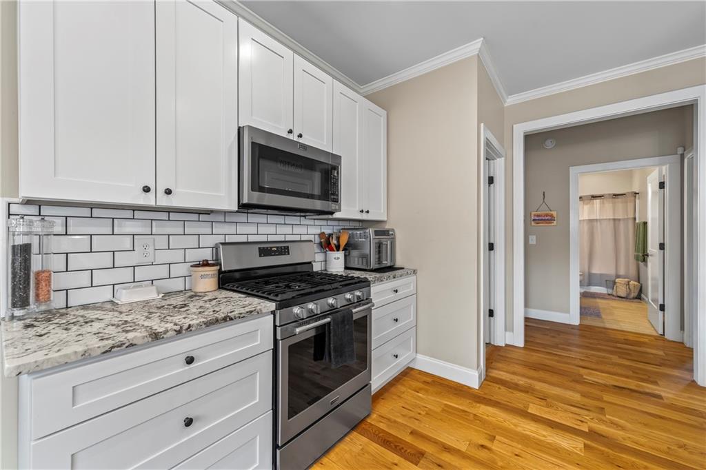 5240 Highway 17 Clarkesville, GA 30523 - Photo 39 of 82 a kitchen with granite countertop cabinets stainless steel appliances and wooden floor