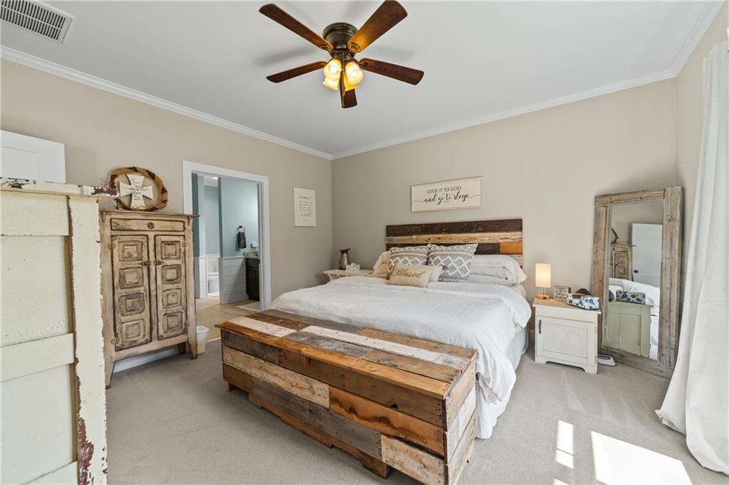 5240 Highway 17 Clarkesville, GA 30523 - Photo 50 of 82 a bedroom with a bed and a chandelier