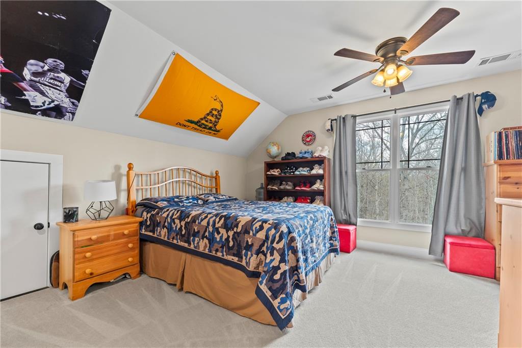 5240 Highway 17 Clarkesville, GA 30523 - Photo 59 of 82 a bedroom with a bed and a chandelier