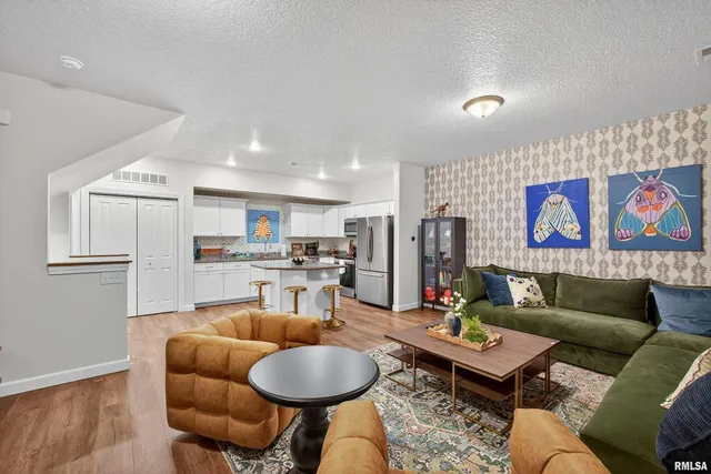 a living room with furniture and kitchen view