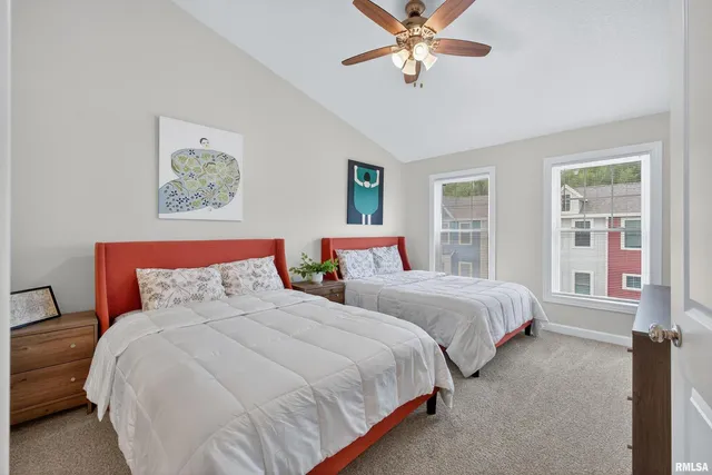 a bedroom with beds and a chandelier